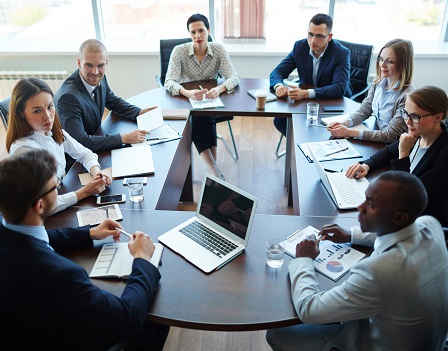 Businespeople at panel discussion in board room