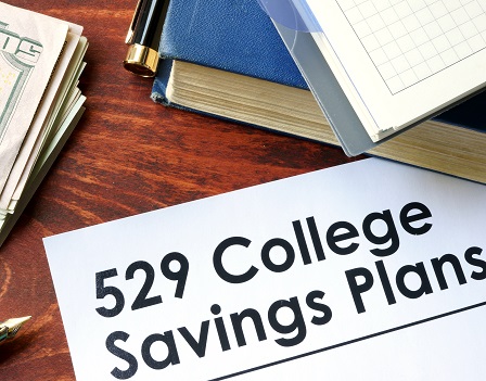 Papers with 529 College Savings Plans on a table.