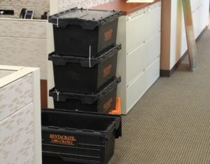 Moving crates are packed, stacked, and ready to move.