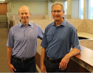 Founding Principals Neal Price and David Copeland pose for one last picture in Suite 270 on July 12.