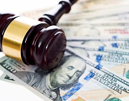 Gavel laying on top of us money.