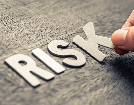 Hand place wood letters for RISK word