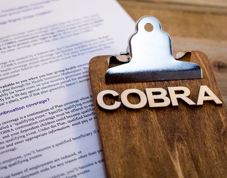 COBRA Healthcare Insurance Benefits for Unemployment concept on wooden board