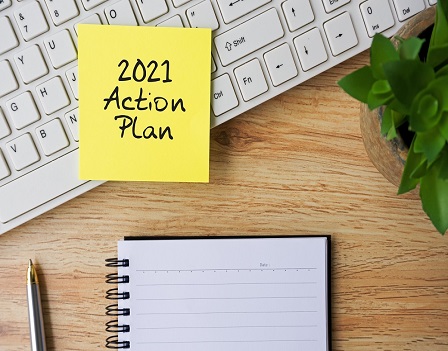 2021 action plan on adhesive note on top of computer keyboard