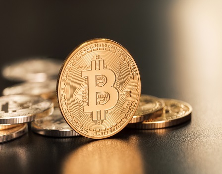 Sofia, Bulgaria - April 24, 2014: Studio shot of golden Bitcoin virtual currency. Close-up of front side.